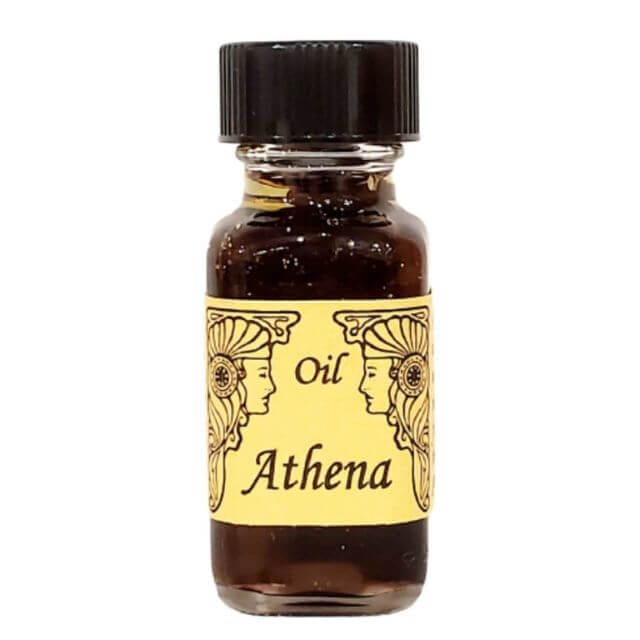 「オイル アテナ」とラベルが貼られた小さなガラス瓶には、女神の横顔の装飾イラストが描かれており、黒いキャップが特徴です。この魅惑的なメモリー オイル、またはメモリー オイルは、女神の存在と繁栄を呼び起こします。.